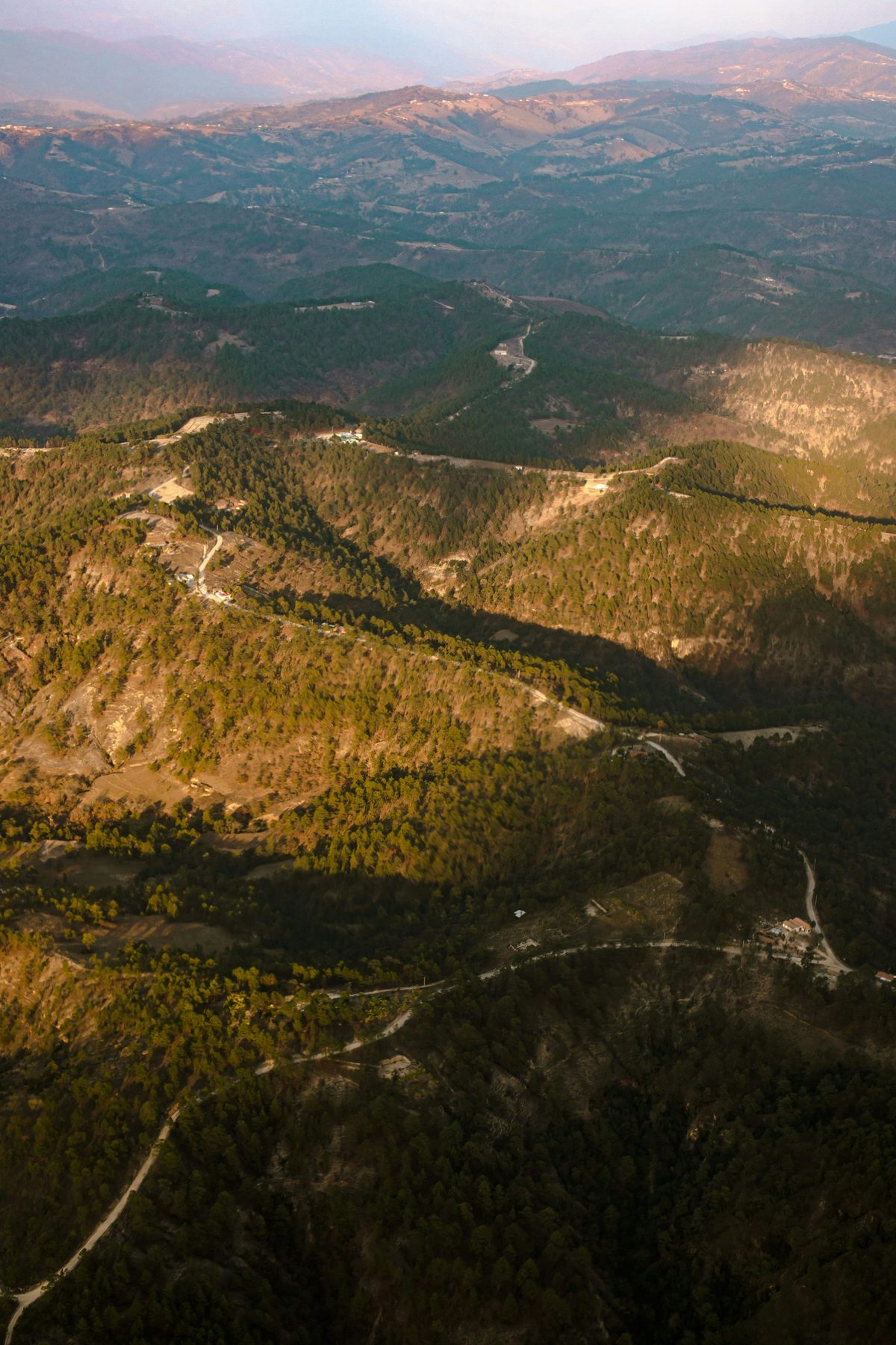 Aerial view of the Guatemalan highlands with roads winding through the hills